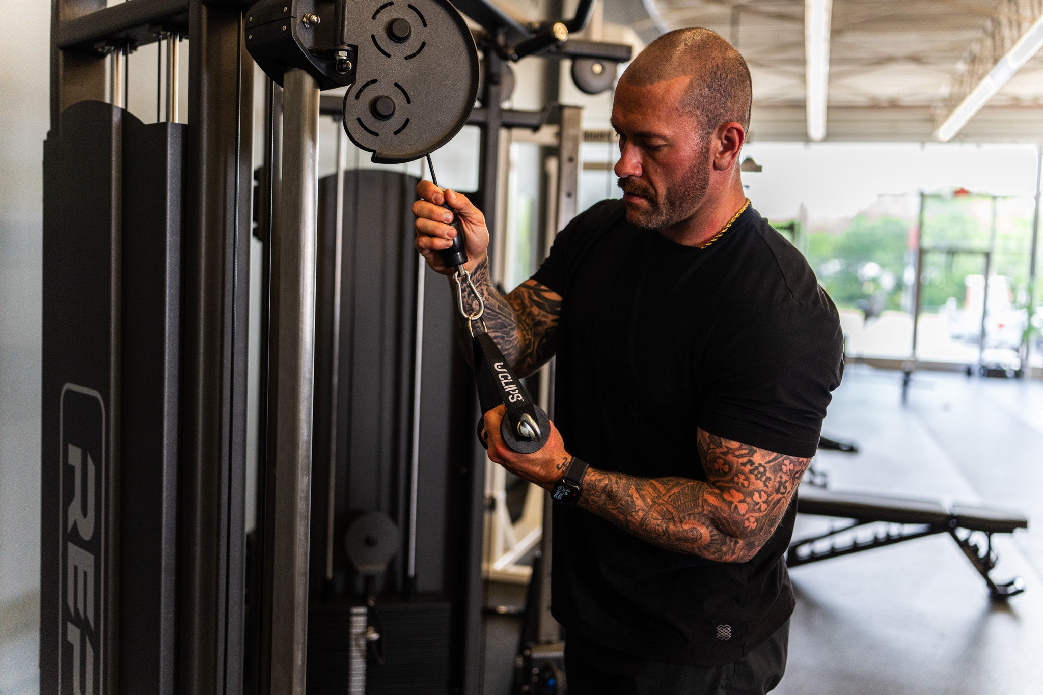 Mid-rep on the cable stack, hand wrapped around the Smile Handle
