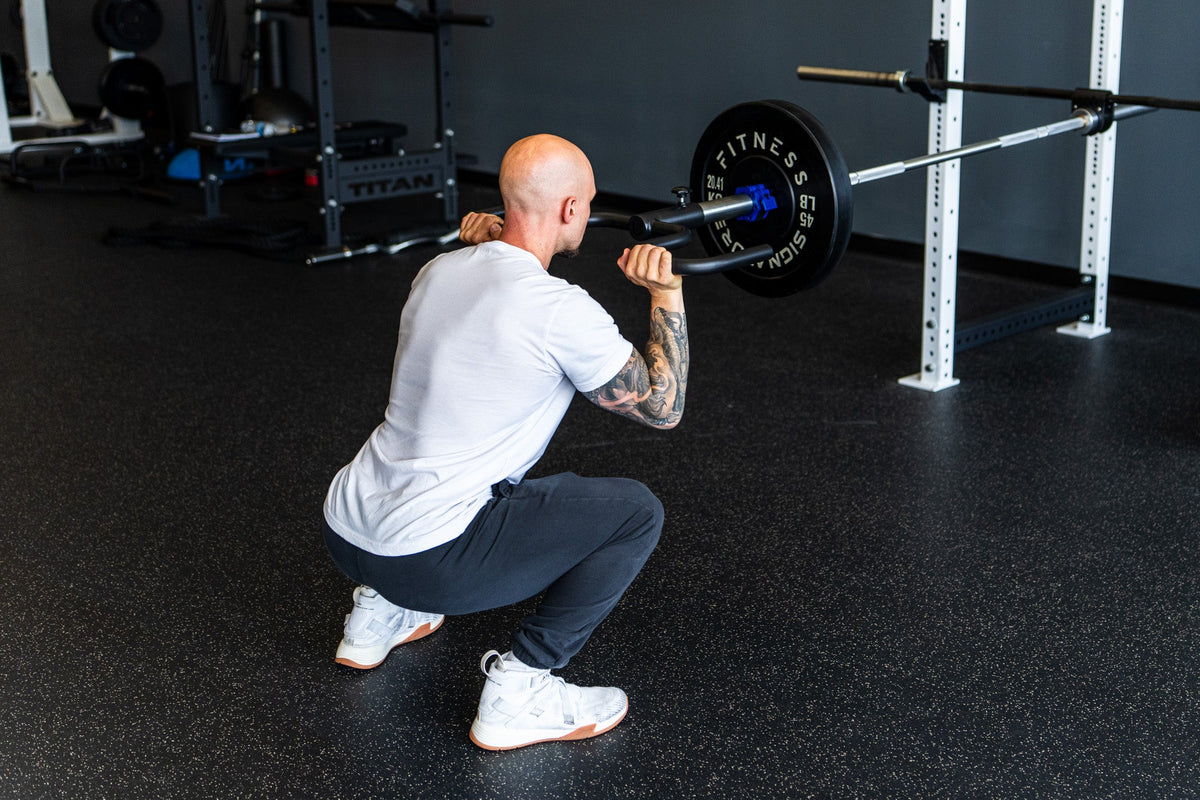 Lifter holding the Viking Press in a loaded front-squat rack position